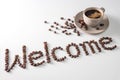 Coffee cup and text made of coffee beans, isolated on white. text the word Welcome made of coffee beans. font Royalty Free Stock Photo