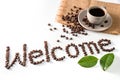 Coffee cup and text Welcome made of coffee beans, isolated on white Royalty Free Stock Photo