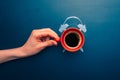 Coffee cup top view with manual alarm clock on a chalkboard background. Break time, good morning, drinks menu design Royalty Free Stock Photo