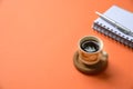 Coffee cup on vibrant orange tabletop. Copy space Royalty Free Stock Photo