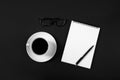 Coffee cup and white notepad with pen on black background. top view Royalty Free Stock Photo