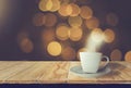 Coffee cup white  placed on wooden table with smoke With night background,bright golden bokeh, glittering with warm vintage color Royalty Free Stock Photo