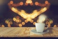 Coffee cup white  placed on wooden table with smoke With night background,bright golden bokeh, glittering with warm vintage color Royalty Free Stock Photo