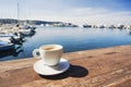 Coffee cup on a wood table over blue sky and sea background. Summer holiday concept Royalty Free Stock Photo