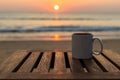 Coffee cup on wood table at sunset or sunrise beach Royalty Free Stock Photo