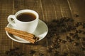 Coffee cup on wooden background/Coffee cup, cinnamon sticks and sticks cinnamon on wooden background Royalty Free Stock Photo