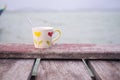 Coffee cup on wooden table with blur river water sea background Royalty Free Stock Photo