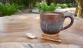 Coffee cup on wooden table in the garden