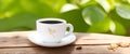 Coffee cup on a wooden table with green leave background. Hot black coffee cup. coffee cup on blurry background