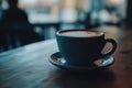 Coffee cup on a wooden table with a programming setup showcasing JavaScript for web development