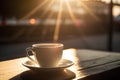 Coffee cup on wooden table in coffee shop with sunlight background