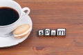 Coffee cup on a wooden table and text - Spam