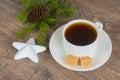 Coffee cup with xmas tree branch and star bauble Royalty Free Stock Photo