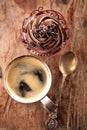 Coffee and cupcake in rustic style on wooden table