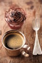 Coffee and cupcake in rustic style on wooden table