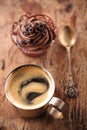 Coffee and cupcake in rustic style on wooden table