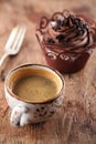 Coffee and cupcake in rustic style on wooden table