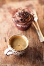 Coffee and cupcake in rustic style on wooden table