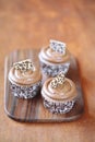 Coffee Cupcakes on a wooden cutting board.