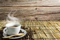 Coffee cups and coffee beans with smoke on bamboo and old wooden background. Copy space Royalty Free Stock Photo