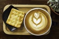 coffee cups with crackers and wooden background