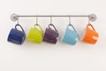 Colorful cups on metal rack Royalty Free Stock Photo