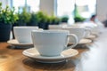 Coffee cups lined up on table Royalty Free Stock Photo