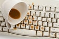 Coffee and damaged computer keyboard Royalty Free Stock Photo