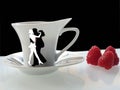 Coffee cup with dance piople and raspberry Royalty Free Stock Photo