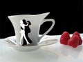 Coffee cup with dance piople and raspberry