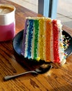 Coffee Date with Rainbow Layer Cake Royalty Free Stock Photo