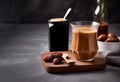 Coffee with date syrup and vegetable milk in glass beaker on gray background. Date syrup trendy. Close-up. Emty space