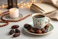 Coffee, dates, prayer beads, and candle on table Royalty Free Stock Photo