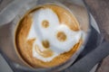 Coffee decorated with a smiley face figure