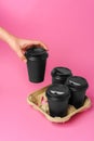 Coffee delivery. Human hand holding takeaway coffee cup