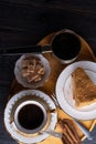 coffee with dessert served at wooden tray at black wooden table. food and wellness concept. flat lay Royalty Free Stock Photo