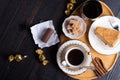 coffee with dessert served at wooden tray at black wooden table. flat lay Royalty Free Stock Photo