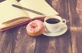 Coffee, donut and notepad on wooden background Royalty Free Stock Photo