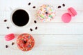 Coffee, donuts and macaroons, flat lay over white wood