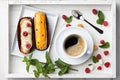 Coffee drink with eclairs in wooden tray