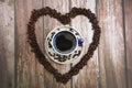 Coffee drink in a mug and black coffee beans in a heart shape Royalty Free Stock Photo
