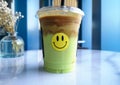 Coffee drink with a smily face on it - Pistachio ice coffee Latte Royalty Free Stock Photo