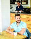 Coffee drinkers live longer. Man bearded guy drinks cappuccino wooden table cafe. Cafe visitor happy smiling face enjoy