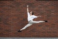 Jumping young woman in front of buildings, on the run in jump high Royalty Free Stock Photo