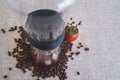 Coffee drip brewing machine, with coffee beans and an old grinder around.