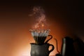 Coffee Drip Concept. Dripper, Mug and Kettle with Motion Steam. Dramatic lighting