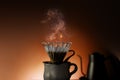 Coffee Drip Concept. Dripper, Mug and Kettle with Motion Steam. Dramatic lighting Royalty Free Stock Photo