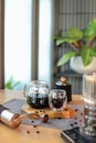 Coffee drip in glass on the wooden plate with a grinder and coffee bean Royalty Free Stock Photo