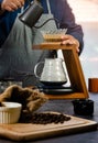 Coffee drip maker. Barista pouring hot water over coffee with paper filter Royalty Free Stock Photo