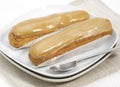 COFFEE ECLAIR ON PLATE Royalty Free Stock Photo